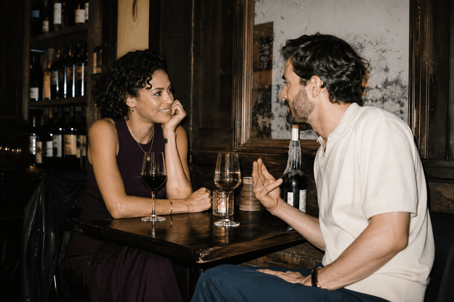 Two people sharing a genuine conversation at a wine bar