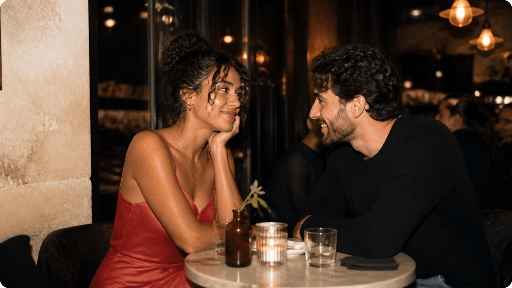 A couple sharing a romantic conversation over dinner under direct flash photography